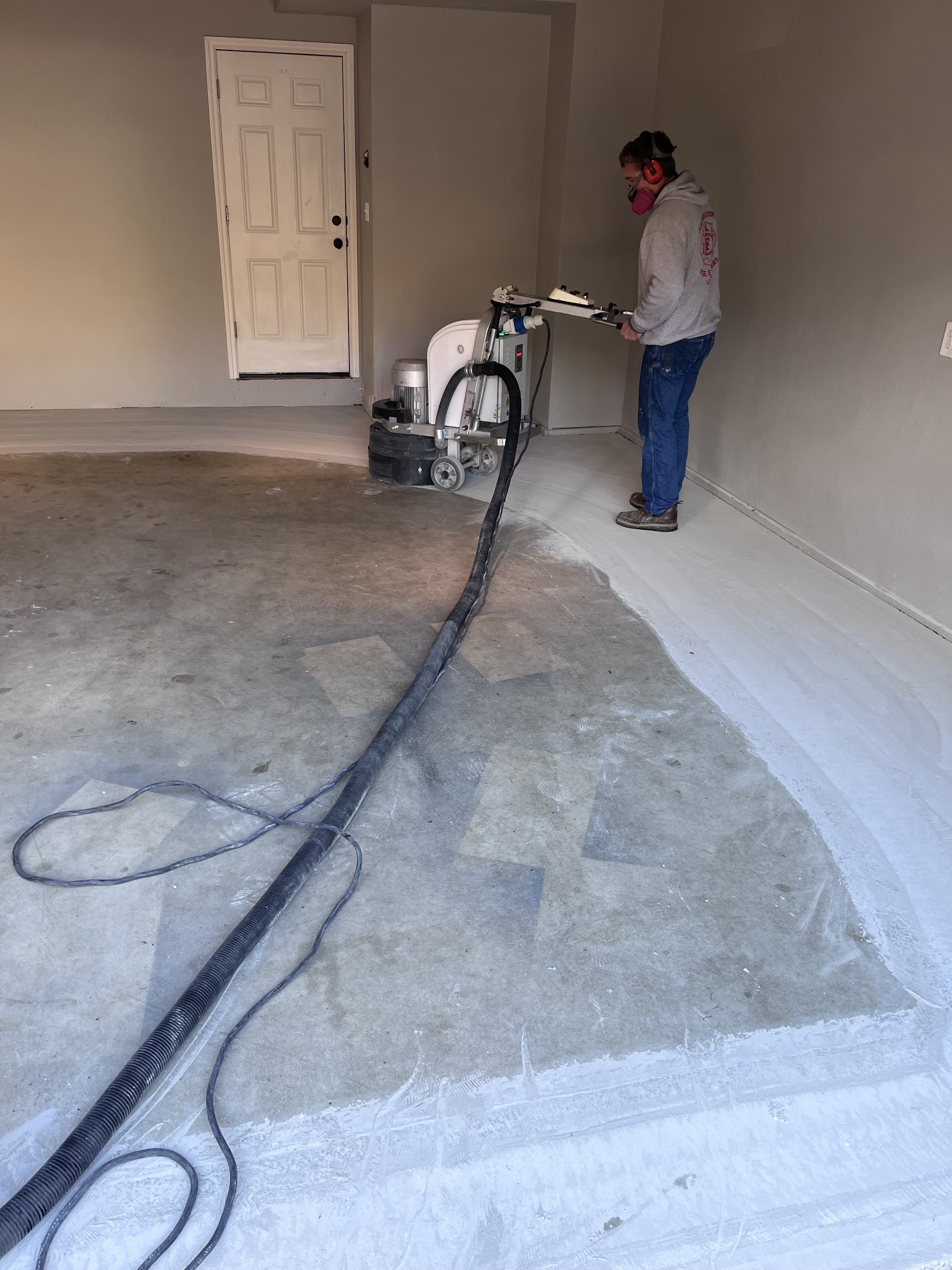 Tim grinding and prepping a garage floor ahead of an epoxy coat