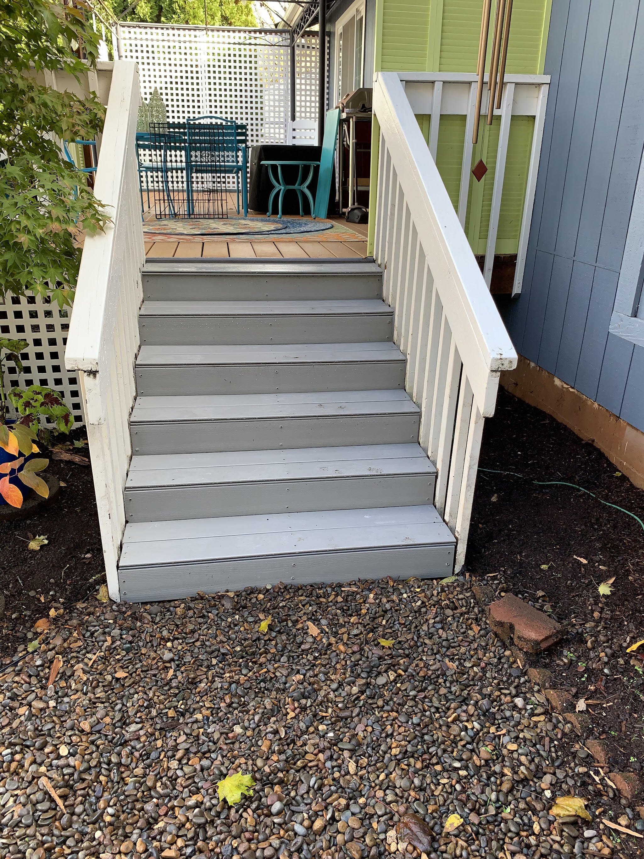 Rebuilt exterior deck stairs leading up to a backyard patio